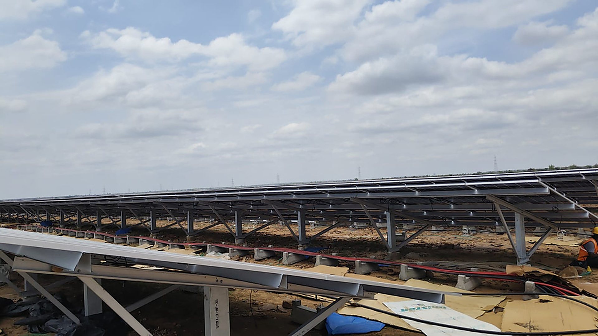 Rows of module mounting structures and installed panels at the 8.8 MW Owk solar plant