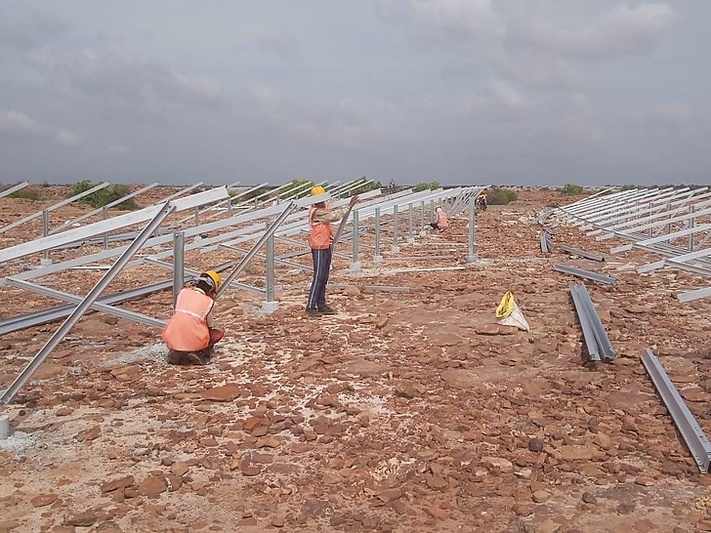 Crew erecting module mounting structures on rocky terrain